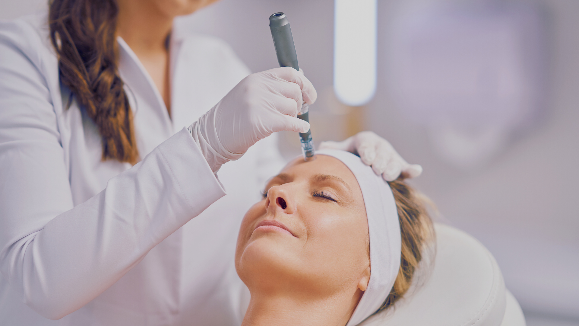 Woman getting microneedling cosmetic procedure